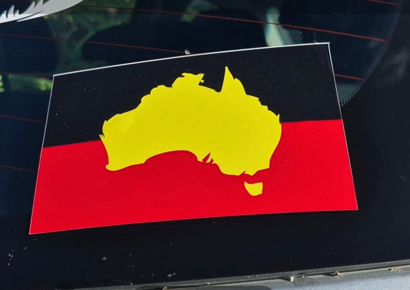 Sticker of Australia with red, yellow, and black colors on a dark surface