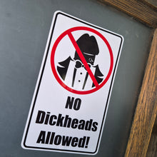 Load image into Gallery viewer, Sticker with a humorous message 'No Dickheads Allowed!' on a reflective surface.
