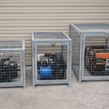 Load image into Gallery viewer, Three metal cages with generators inside against a wall.
