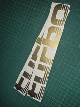 Load image into Gallery viewer, Turbo decal on a green cutting mat
