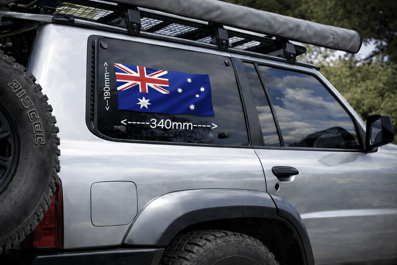 Silver SUV with Australian flag decal on window, surrounded by natural scenery