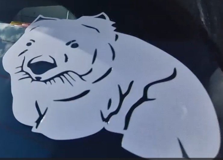 Cartoonish bear decal on a car window