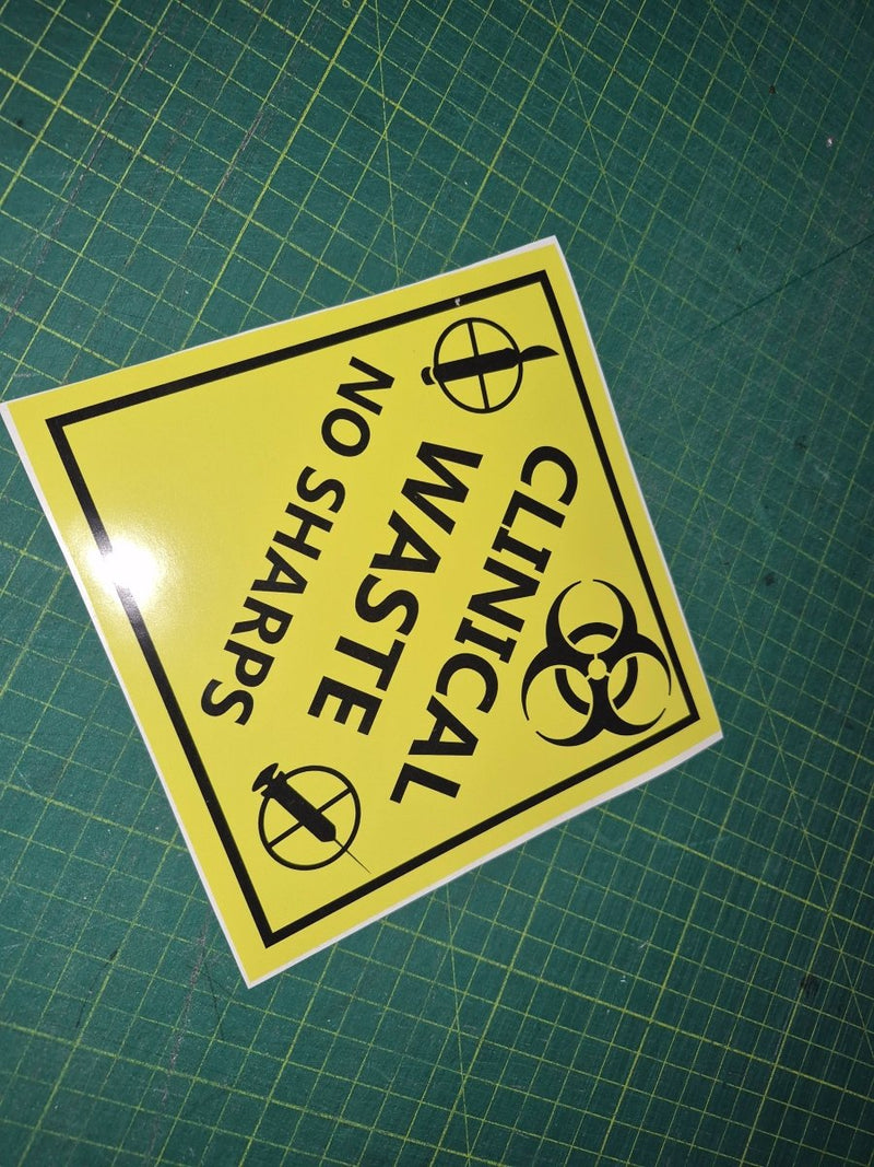 "Yellow clinical waste  no sharps " warning sign decal with black text and symbols on a green grid background