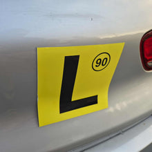 Load image into Gallery viewer, Yellow learner's magnet with a black 'L' on a car's rear.
