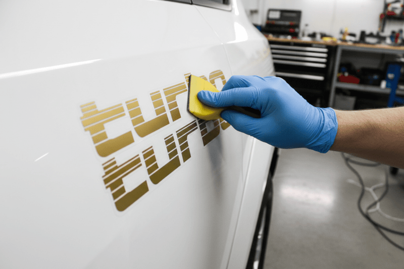 Applying gold Turbo sticker with squeegee