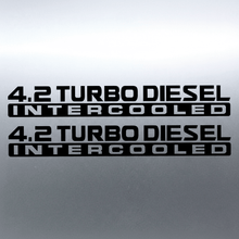 Load image into Gallery viewer, Black 4.2 Turbo Diesel Intercooled stickers on grey panel
