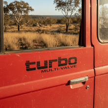 Load image into Gallery viewer, Black Turbo Multi-Valve sticker on 4WD door panel in Australian bush

