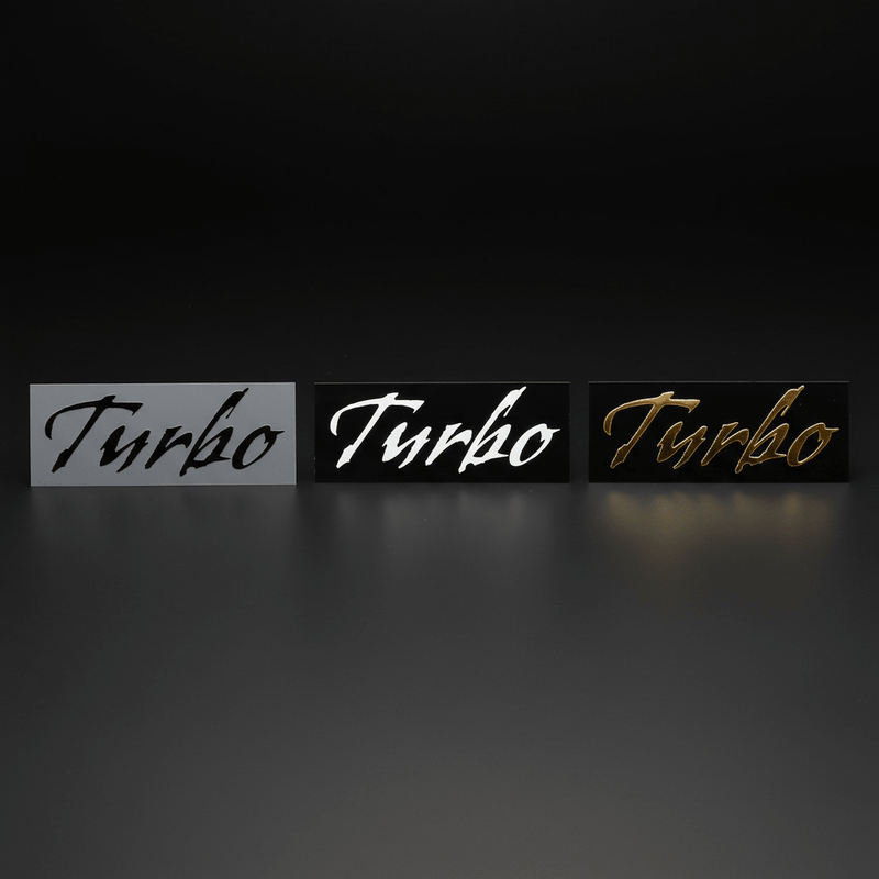 Black, white and gold Gothic Turbo stickers side by side