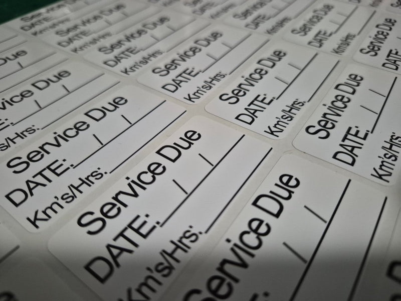 Sheet of car service due labels with fields for date, mileage, and service details.