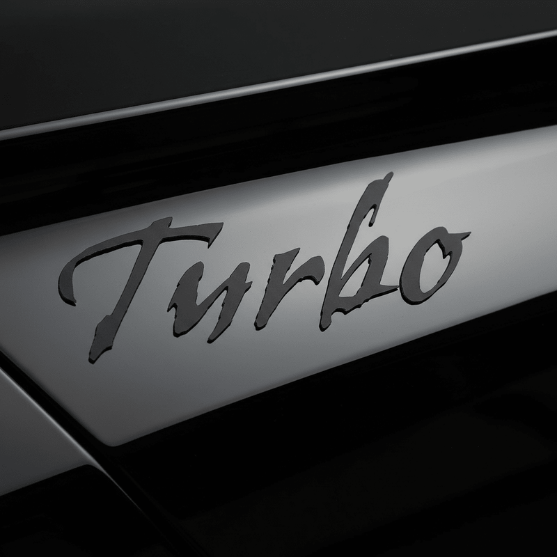 Close-up of black Gothic Turbo sticker on gloss black panel