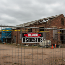 Load image into Gallery viewer, Danger Asbestos on chain-link fence
