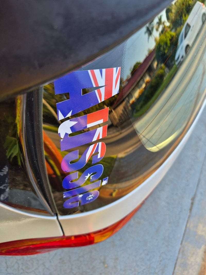 Car window with 'Aussie' decal featuring the Australian flag