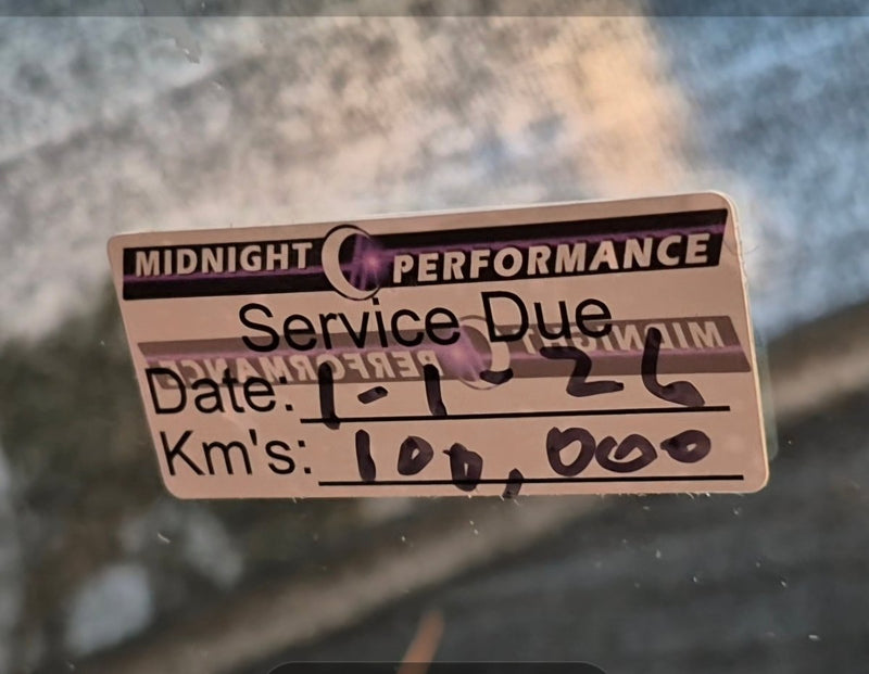 double sided Service due sticker on a car window with 'Midnight Performance' branding