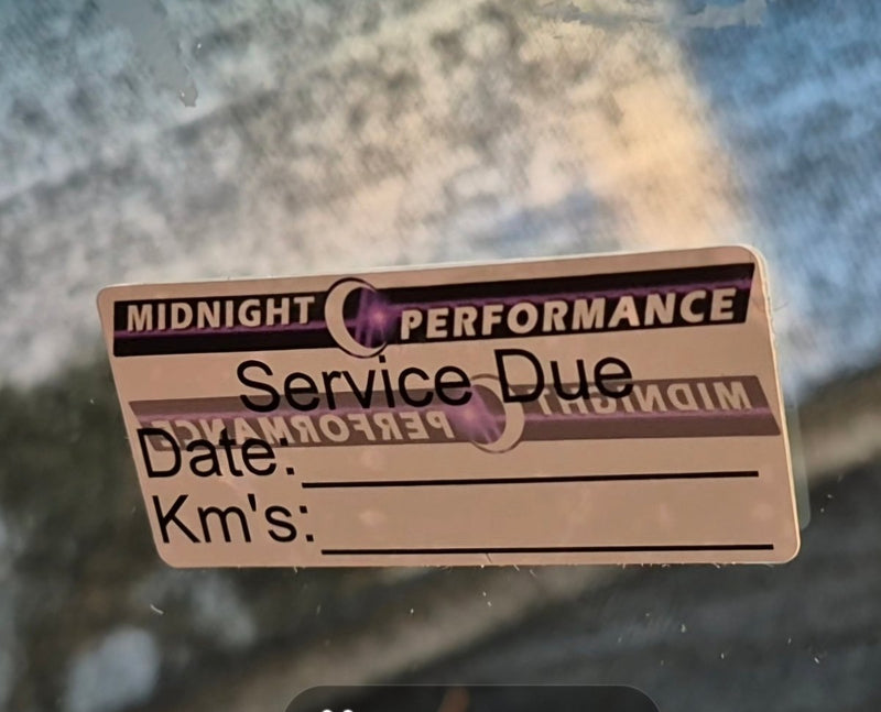 Service due sticker on a glass surface with a blurred background