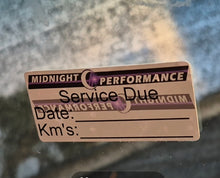 Load image into Gallery viewer, Service due sticker on a glass surface with a blurred background
