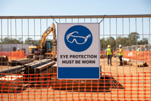 Load image into Gallery viewer, Eye Protection on construction fence
