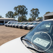 Load image into Gallery viewer, Fleet of white work vehicles with custom branded inspection sticker inset
