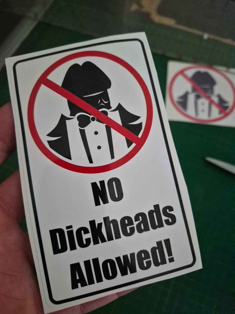 Sticker with 'No Dickheads Allowed!' text and a prohibition symbol on a green background