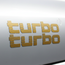 Load image into Gallery viewer, Gold Turbo sticker low angle sunlight
