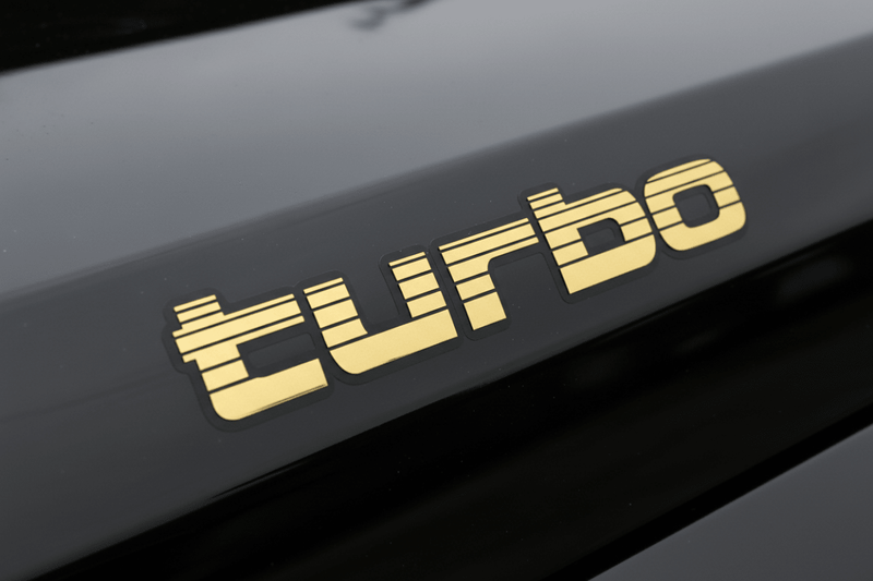 Gold Turbo sticker on black 4WD panel