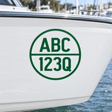 Load image into Gallery viewer, Green cut-vinyl round boat registration decal on a white hull
