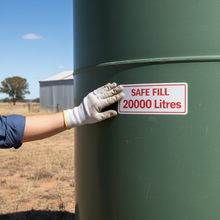 Load image into Gallery viewer, Hand applying Safe Fill 2000 Litres sticker to farm fuel tank
