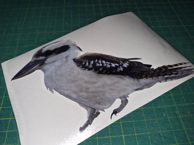 Bird decal on a white sheet with a green cutting mat background