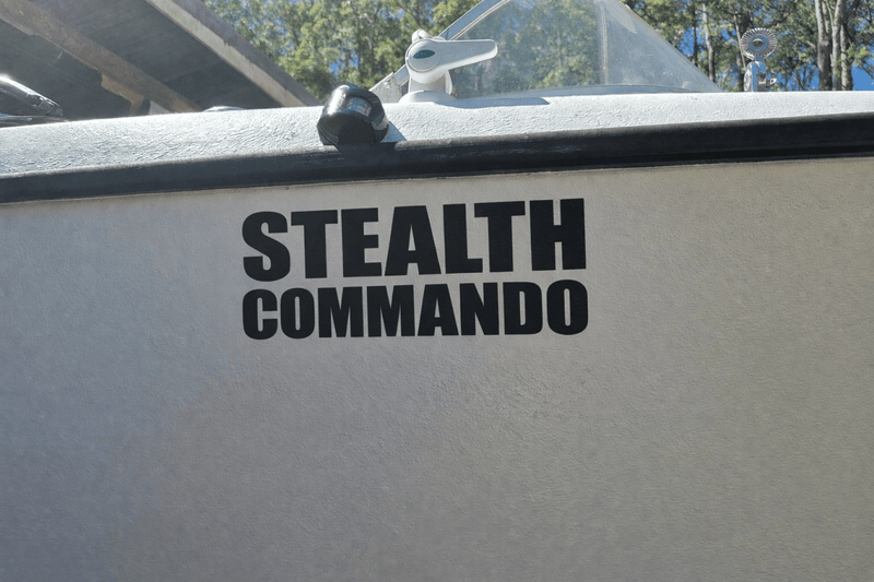 custom boat name Decal on the side of a boat with 'Stealth Commando' text