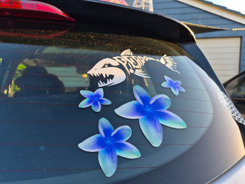 Car window with decal of blue Frangipani flower stickers