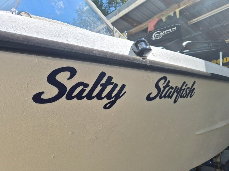 Boat with 'Salty Starfish' decal on a docked boat.