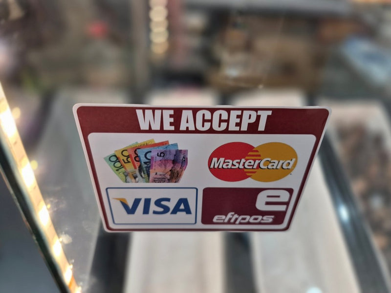 Payment acceptance sign for Visa, MasterCard, and EFTPOS on a blurred background