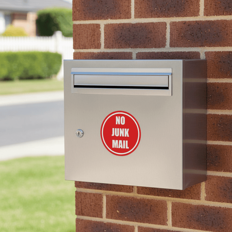 Red round sticker on stainless letterbox