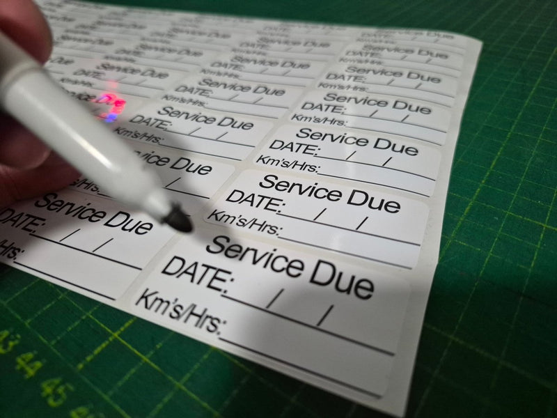 Service due card with a marker on a green cutting mat