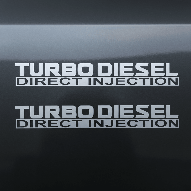 Satin silver-grey Turbo Diesel Direct Injection stickers doubled on dark background