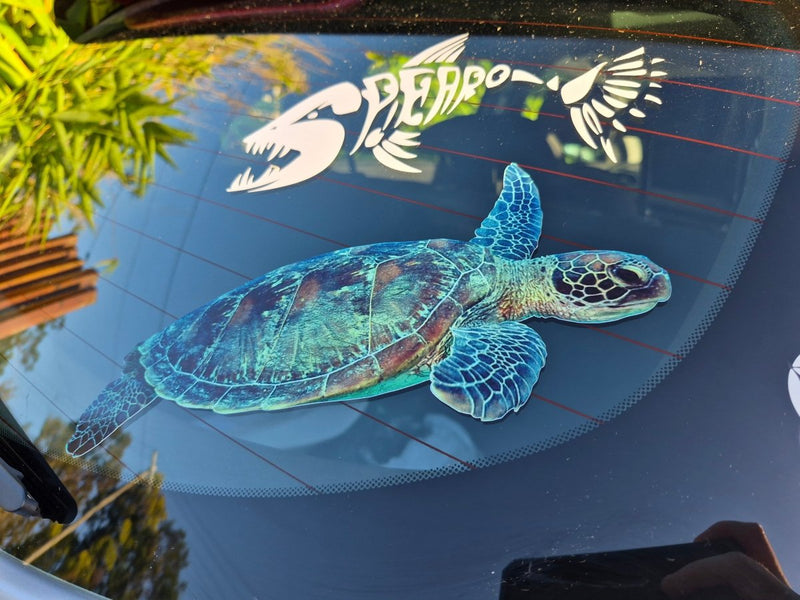 Car window with a turtle decal and 'Deppo' logo in the background