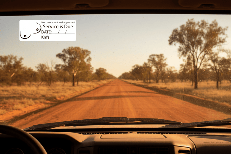 Service due sticker on dusty 4WD outback
