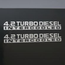 Load image into Gallery viewer, Silver-grey 4.2 Turbo Diesel Intercooled stickers on dark background
