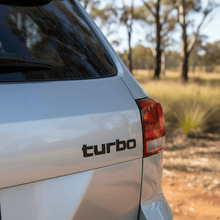 Load image into Gallery viewer, Small black turbo sticker on 4WD rear tailgate
