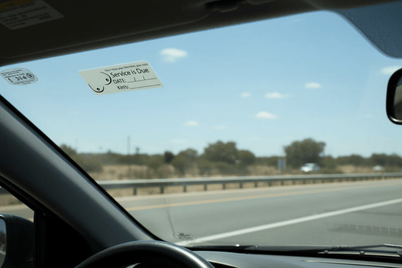 Sticker on windscreen driver POV highway