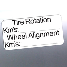 Load image into Gallery viewer, Label for tire rotation and wheel alignment with fields for kilometers on a reflective surface.

