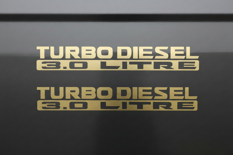 Two matte gold Turbo Diesel 3.0 Litre stickers stacked