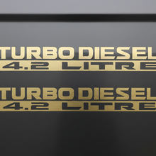 Load image into Gallery viewer, Two matte gold Turbo Diesel 4.2 Litre stickers stacked
