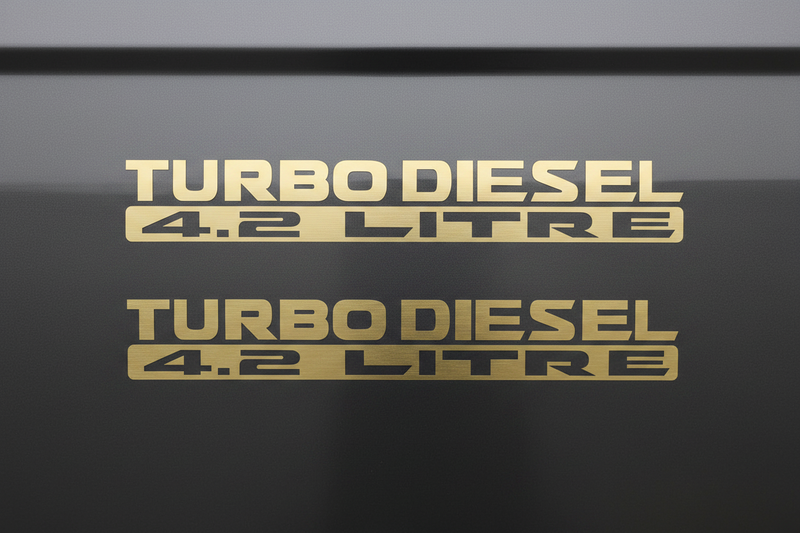 Two matte gold Turbo Diesel 4.2 Litre stickers stacked