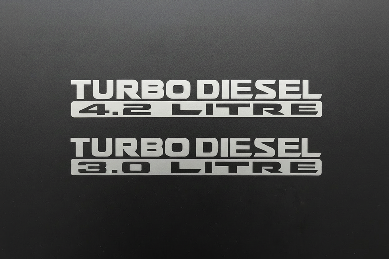 Two silver-grey Turbo Diesel 3.0 Litre stickers stacked