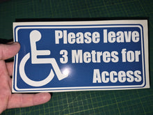 Load image into Gallery viewer, Handheld sign with wheelchair icon and text 'Please leave 3 Metres for Access' on a blue background.
