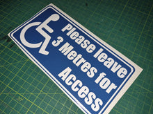 Load image into Gallery viewer, Blue and white sign with wheelchair icon and text on a green cutting mat
