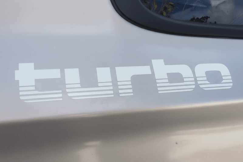 White 100 Series Turbo sticker on white vehicle panel