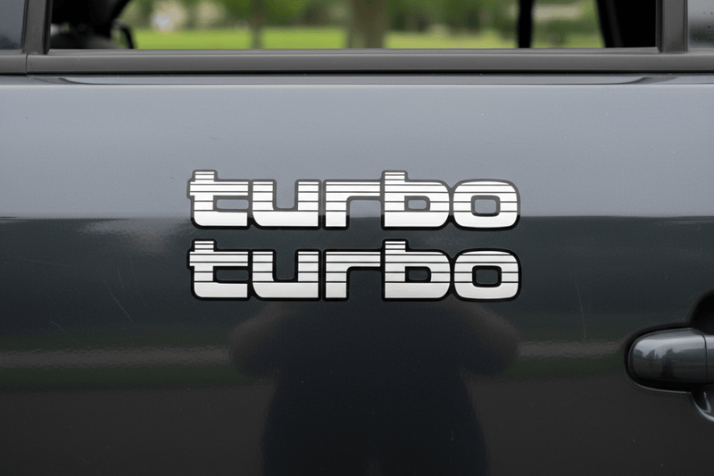 White Turbo sticker on dark charcoal 4WD panel