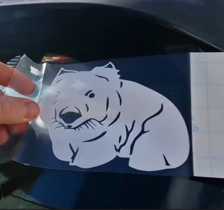 White tiger decal being applied to a car window