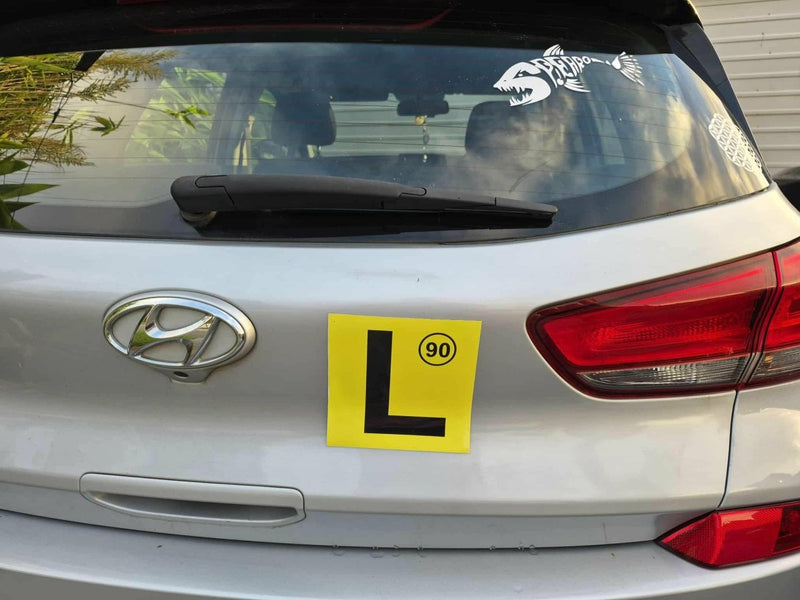 Hyundai car with a yellow learner's license plate on the back